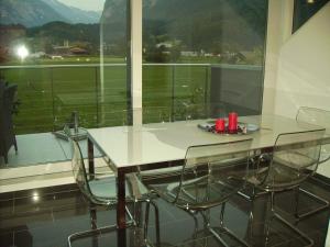 a table and chairs in a room with a window at Mountain-Panorama in Meiringen