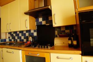 a kitchen with yellow cabinets and a stove top oven at Agriturismo Il Fantone in Scansano