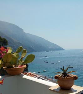 a view from the balcony of a house overlooking the ocean at La Dolce Vita a Positano boutique hotel in Positano