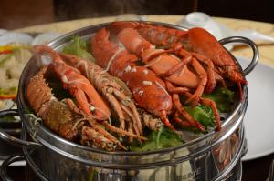 a glass bowl filled with lobsters on top of lettuce at Moon Villa in Zhongpu