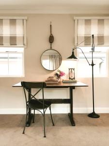 a dining room table with a chair and a mirror at Bosch Hoek Golf & Lodge in Balgowan