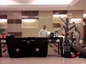 a man standing behind a table in a room at De Luxe, Standard and Studio Suites -The Breeze Residences-close to Airport,Mall of Asia, US Embassy in Manila +74 photos