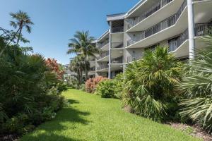 an apartment building with palm trees and grass at Coconut Palms in Key West