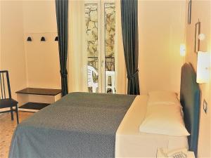Postel nebo postele na pokoji v ubytování Hotel Britannia