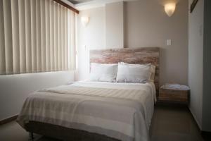 A bed or beds in a room at 212 Hotel