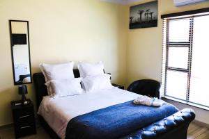 Ein Bett oder Betten in einem Zimmer der Unterkunft Estoby Executive guest house