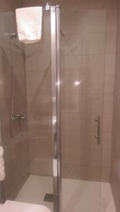 a shower with a glass door in a bathroom at El Raco De Navarrete in Cabanes