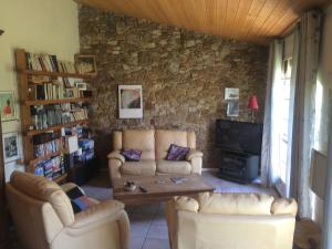 a living room with couches and a coffee table at L Armance in Fublaines