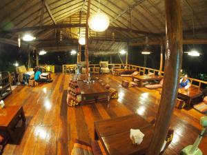 a large room with wooden floors and wooden tables at LITTLE EDEN Bungalows in Ko Chang