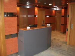 a room with wood paneling and a reception desk at Aparthotel del Golf in Sant Cugat del Vallès