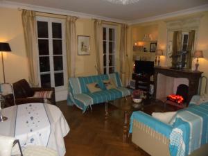 ラ・ロシェルにあるSur Le Vieux Port Appartement Vue Sur Merのリビングルーム(青いソファ、テレビ付)