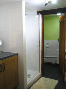 a bathroom with a shower with a glass door at Sweetheart House in Harrogate