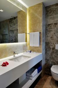 a bathroom with a sink and a toilet at Luga Boutique Hotel & Beach in Ortakent