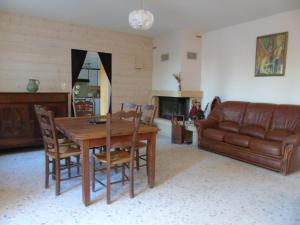 a living room with a table and a couch at La Maison de l'Ormeau in Montauban