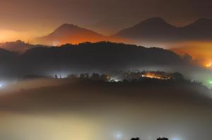 a view of a foggy valley with mountains in the background at Sun Moon Lake Jinlongshan BnB in Yuchi