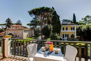 a table on a balcony with a view of a house at Appia Park Hotel in Rome