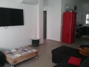 a living room with a red refrigerator and a coffee table at New Trendy apartment in Valencia