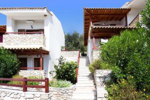 a stairway leading up to a white house at Villa Maraki in Agia Paraskevi
