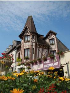 a large building with a sign in front of it at Logis Hôtel et Restaurant du Dauphin in Sées