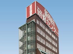 a building with a sign on top of it at S.Training Center Hotel Osaka in Osaka