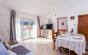 a living room with a table and a large window at Apartments Luka in Baška