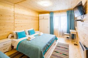 a bedroom with a bed in a wooden room at Family Hotel Cascad in Bukovel
