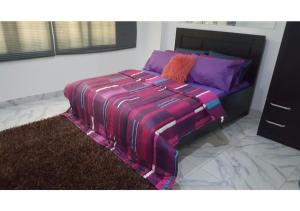 a bed with a colorful blanket on it in a room at Large 1 Bedroom Apartment On The Gound Floor, Lekki in Lekki