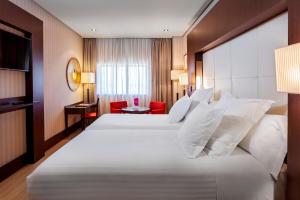 A bed or beds in a room at Barceló Granada Congress