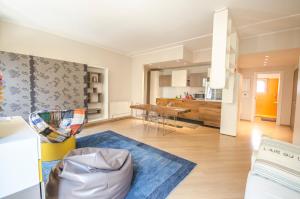 a living room with a kitchen and a dining room at Luxury 65mq under the two towers in Bologna