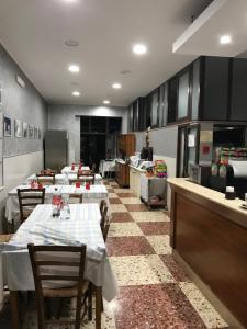 a restaurant with tables and chairs in a kitchen at Il Veliero in Marzamemi
