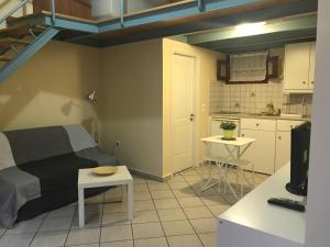 エルムポリにあるErmoupoli, Syros City Apartmentsの小さなベッドルーム(ベッド1台付)、キッチンが備わります。