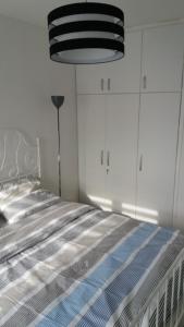 a bedroom with a bed with a blue and white comforter at WHITE CITY 2 in Belgrade