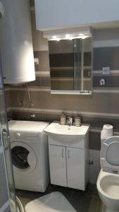 a bathroom with a washing machine and a sink at WHITE CITY 2 in Belgrade