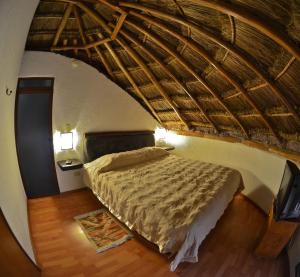 a bedroom with a bed with a straw roof at La Aldea Hotel & Spa in Atlixco +48 photos