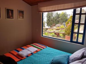 Postel nebo postele na pokoji v ubytování Cabañas Yukatan Lago de Tota + 37 fotografií