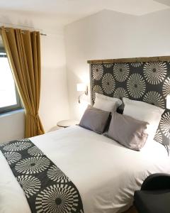 a bedroom with a large bed with a black and white headboard at Appart' Vieil Antibes in Antibes