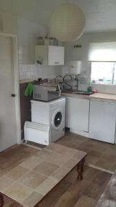 a kitchen with a washing machine in the middle at Mablethorpe Chalet in Mablethorpe