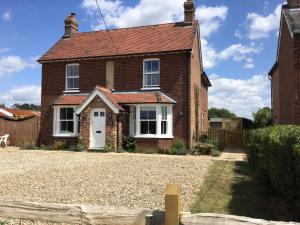 a brick house with a gravel driveway in front of it at Fair View in Marden
