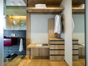 a bathroom with a loft bed with wooden shelves at Donna Carmela Resort & Lodges in Riposto