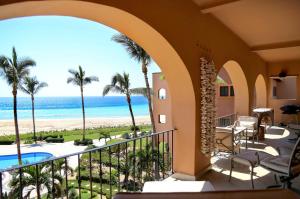 a view of the beach from the balcony of a resort at Condominios Brisa - Ocean Front in Cabo San Lucas