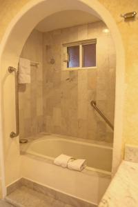 a bathroom with a bath tub with a window at Condominios Brisa - Ocean Front in Cabo San Lucas