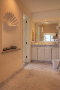 a hallway with a door and a mirror at Condominios Brisa - Ocean Front in Cabo San Lucas