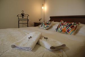 1 cama con 2 toallas y 2 almohadas en Evergreen en La Cumbre