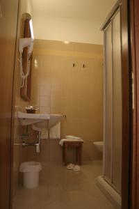 a bathroom with a sink and a toilet at Hotel Centro di Spiritualità Padre Pio in San Giovanni Rotondo