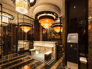 a lobby with a marble counter and chandeliers at APA Hotel Iidabashi-Eki Minami in Tokyo