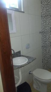 a bathroom with a sink and a toilet at Hotel Vitalle in Juiz de Fora