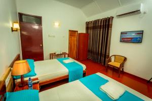 En eller flere senger på et rom på Dayanithi Guest House