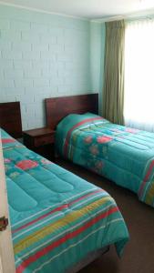 a bedroom with two beds and a window at Santa Margarita Coquimbo in Coquimbo