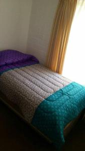 a bed sitting in a bedroom with a window at Santa Margarita Coquimbo in Coquimbo +4 photos