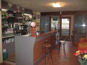 a bar in a restaurant with bar stools at Antica Osteria Pace in Moerna